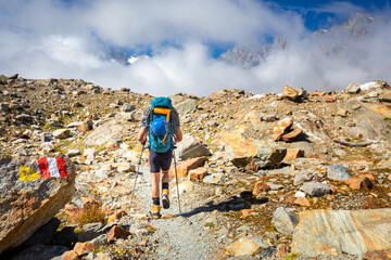 Mountaineer tourist walking hiking Alps mountains trail