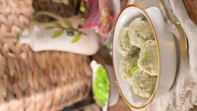 North italian traditional dish. Canederli or Knodel in broth with green onion, typical pasta for Trento, Alps, Alto Adige, Italian, Austrian cuisine. High quality 4k footage. Vertical video