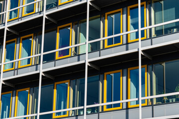 Facade of the building with rectangular yellow windows.