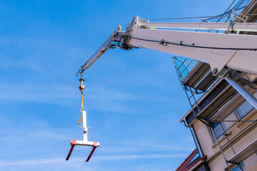 Construction crane boom with a load feeder.