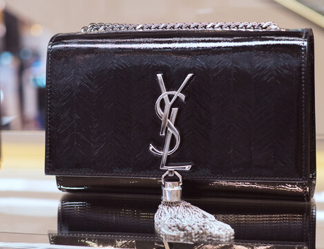 Elegant Black Clutch Bag With Large YSL Silver Logo By Yves Saint Laurent.