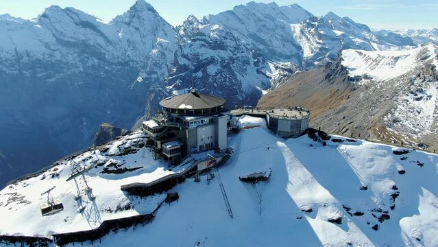 fantastic circular aerial shot of the Schilthorn piz Gloria on a sunny autumn day. The funicular can be seen in motion. A James Bond movie was filmed in this place.