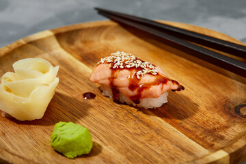 Sushi with smoked eel and sesame seeds on a black background. Japanese dish Unagi sushi.