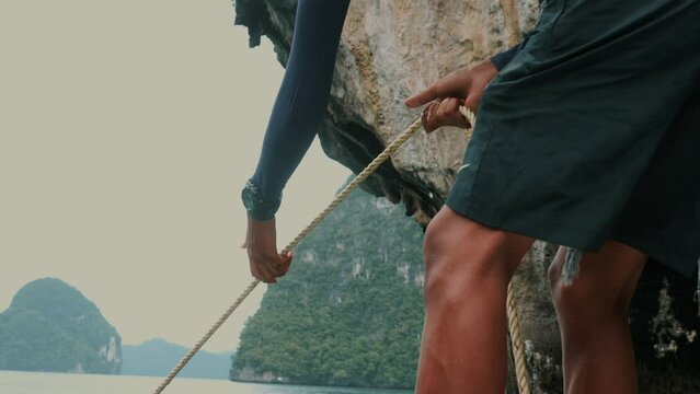 Sailor pulling rope in during traveling on ship vessel 