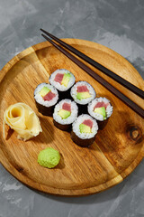Set of tuna sushi rolls on black desk background
