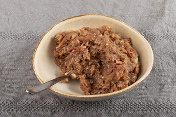 Minced Meat Mix in Round Bowl, Ground Pork, Turkey, Beef and Chicken Meat with Onion and Black Pepper