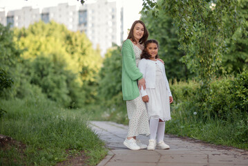 Fototapeta premium happy family mother and child daughter in nature park in summer on green grass.