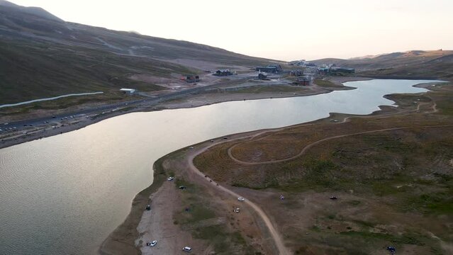 Aerial View From Behind ATVs by Lake and Mountain