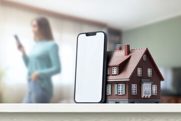Blank smartphone and model house