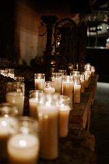 Fototapeta na wymiar lot of candle lightened in the dark 