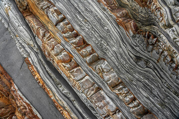 Natural rock texture of a colorful rock formations in silence beach (playa del Silencio) in Asturias, north of Spain.