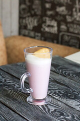Raspberry souffle in a glass goblet. stands on a table of pine boards. Close-up.