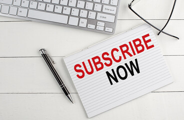 text SUBSCRIBE NOW on a keyboard on white background