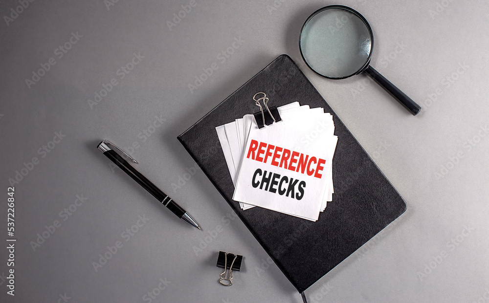 Poster reference checks text on a sticky on black notebook , business concept