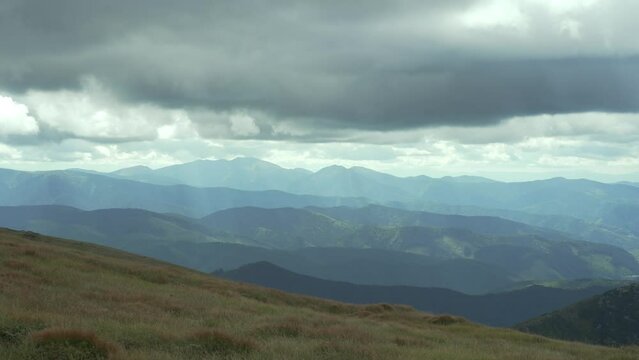 Mountain landscape, green mountains in cloudy weather. Mountains before the rain. Ukrainian Carpathian Mountains. A distant mountain range. Heavy clouds. Peace at the top. High quality 4k footage
