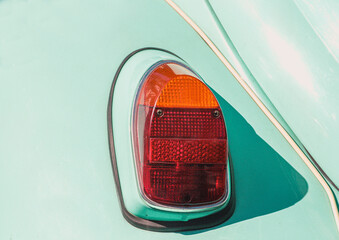 The tail light of a vintage retro car. Retro car brake light. The rear fender of a vintage car is...