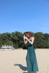 Fototapeta na wymiar beautiful girl in a dress on the beach