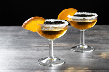 Sidecar cocktail with a sugar rim on wooden table