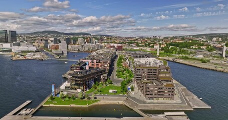 Oslo Norway v12 cinematic drone low level flyover sørengautstikkeren upscale neighborhood with waterfront apartments, panning towards munch museum and opera house - Shot with Mavic 3 Cine - June 2022
