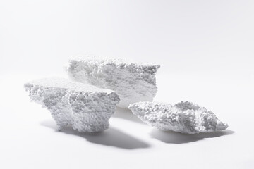 Art white podiums of bubble styrofoam as white stones mockup for presentation and showing cosmetic...