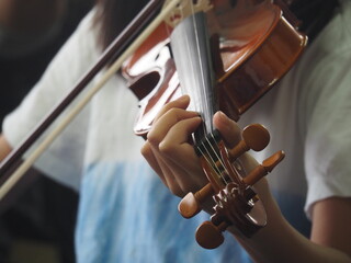 Violin lesson.Child playing the violin in a room. © Boon