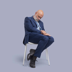 Corporate businessman sleeping on a chair