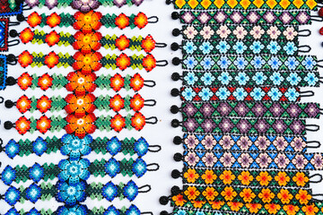 Huichol bracelets and wristbands with flower designs at night market in Guadalajara, Mexico....