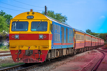 Obraz premium Passenger train by diesel locomotive at the railway station