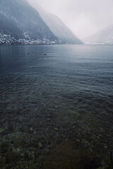 Mountain range with strong atmosphere during a snowy, dark winter afternoon