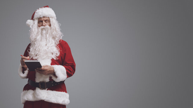 Santa Claus writing on a notebook