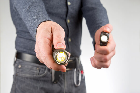 man holds a flashlight in his hand. item for camping and household life