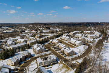 There is small American town in Pennsylvania with residential complex with snowy roof after a severe snowstorm