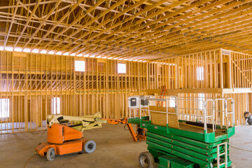 Contractor using boom truck forklift in construction site the under construction home framing beam