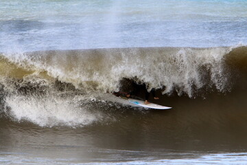 Surfing on high waves on the Mediterranean Sea in northern Israel.