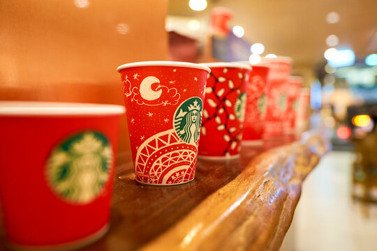 HONG KONG - CIRCA NOVEMBER, 2016: holiday cups at a Starbucks cafe in Hong Kong. Starbucks Corporation is an American coffee company and coffeehouse chain.