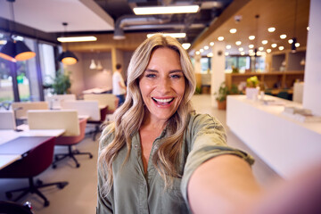 POV Selfie Portrait Of Businesswoman Standing In Modern Open Plan Office