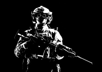 Modern army special forces equipped soldier, anti terrorist squad fighter, elite mercenary armed assault rifle, standing in darkness with night vision goggles on helmet, studio portrait