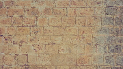 Antique Block Wall. Brickwall. Rough Stonelaying Obsolete Worn Vintage Brick Wall Old Stonewall Texture Grunge background Toned Photo