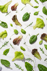 Gray background with lettuce, basil and spinach