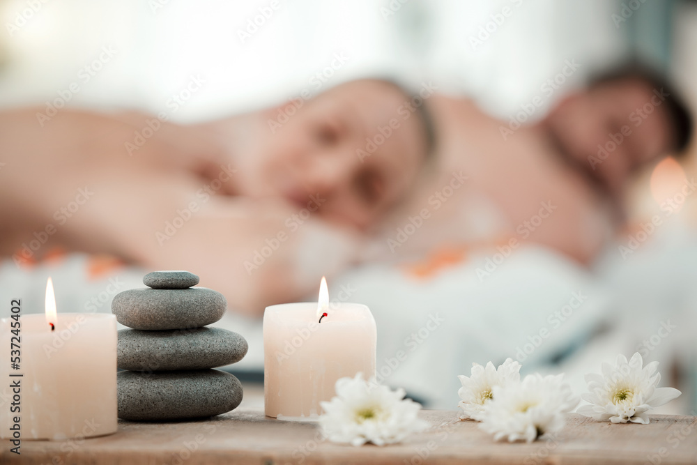 Wall mural Background of aromatherapy candles, spa and couple luxury skincare, zen wellness and relax body at vacation salon. Closeup of massage stones, calm space and holistic beauty service for stress relief