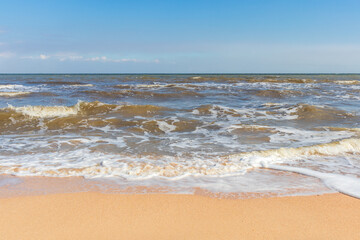 The Black Sea in sunny weather. Surf on the beach, waves,sandy shore