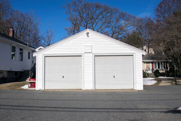 Fototapeta na wymiar Two car Garage as a single building with doors painted in grey color.