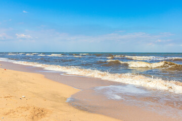 The Black Sea in sunny weather. Surf on the beach, waves,sandy shore