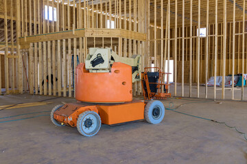 Using boom truck forklift at construction site framing beams under construction, contractor is to move materials.