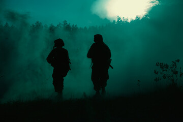 United States Marines in action. Military battle, forest battlefield, smoke grenades