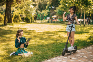 Cute girls spending time in the park and feeling happy