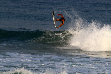 Surfing on high waves on the Mediterranean Sea in northern Israel.