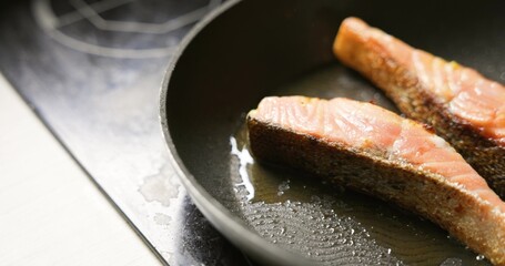 Healthy home salmon in frying pan in the kitchen