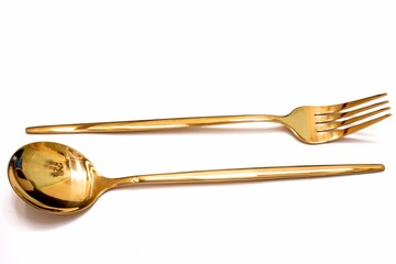 Spoon with golden cutlery isolated on white background.