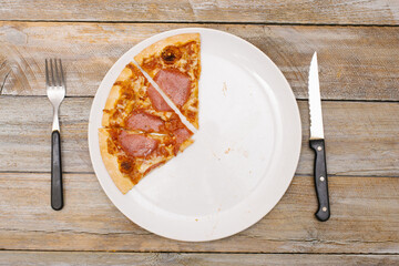 Three eighth - Pizza pieces series as illustration of division in maths on wood table